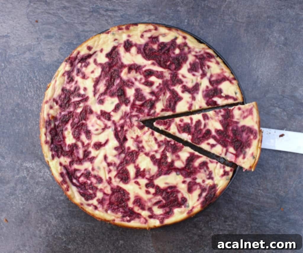 Exotic Passionfruit Raspberry Cheesecake 3 Close-up of a cut slice of Raspberry Passion Fruit Cheesecake