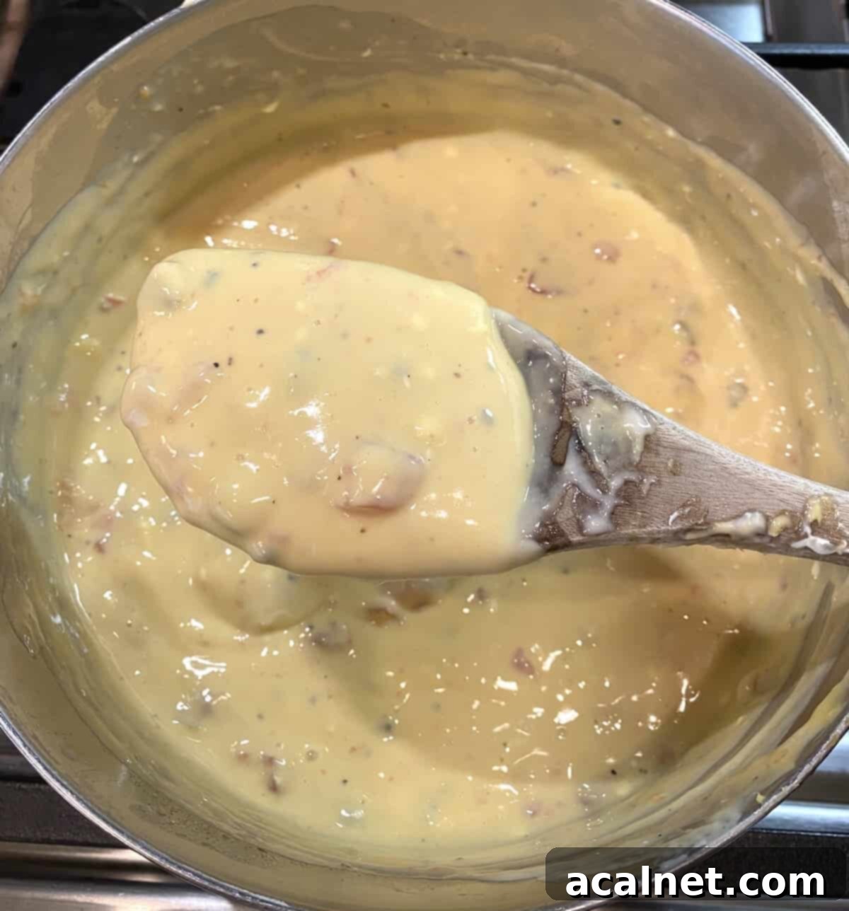 Velveeta cheese sauce in a pan on the stove.