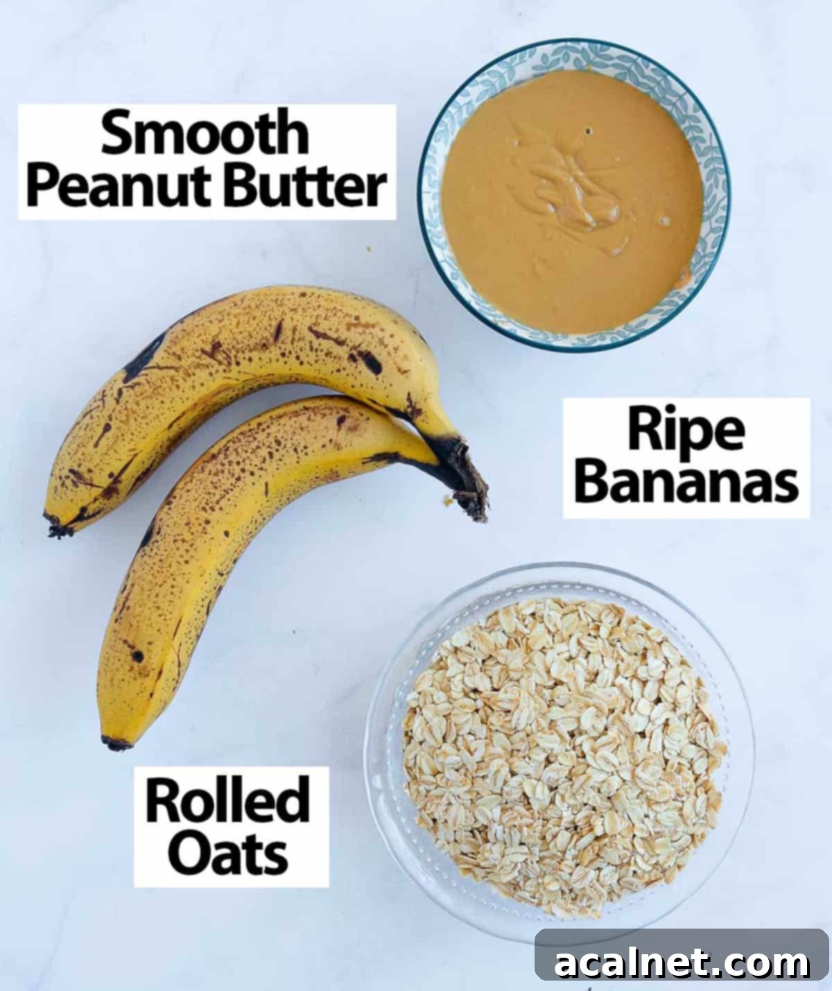 The three core ingredients: ripe bananas, peanut butter, and rolled oats, neatly arranged on a white surface.