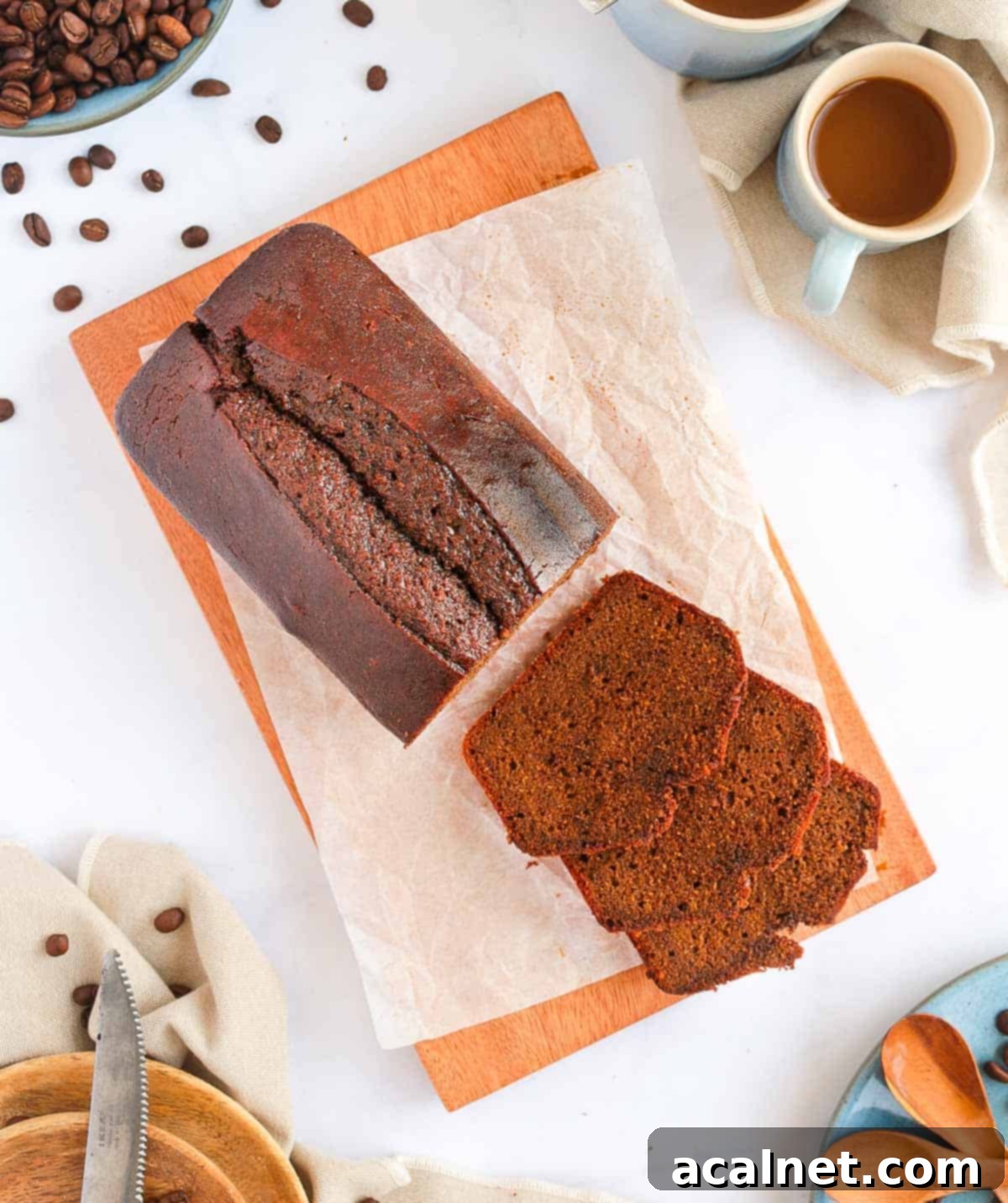 Overhead view of a coffee cake with coffee glaze on a wooden board.