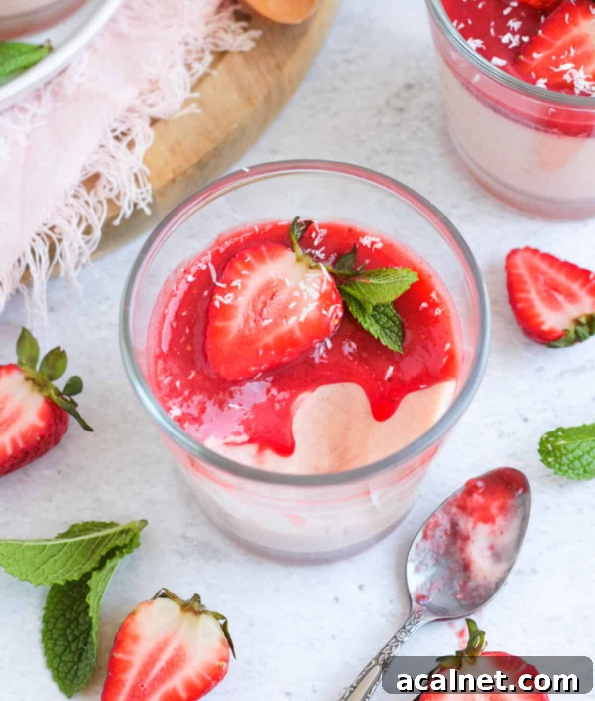 Homemade Strawberry Panna Cotta with Fresh Strawberry Sauce 8 A spoonful of cream taken out of a cup.