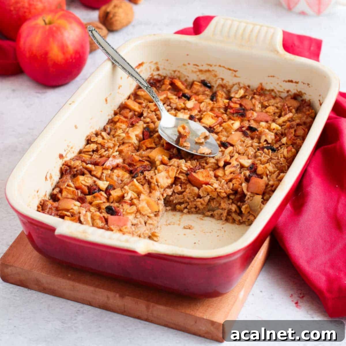 Baked Oatmeal in a white and red ceramic dish with a slice cut off.