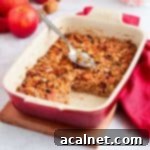 Baked Oatmeal in a white and red ceramic dish with a slice cut off.
