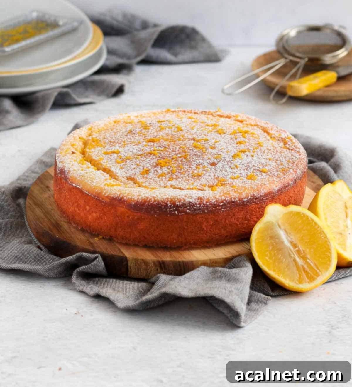 Cake placed over a wooden board on a grey napkin.