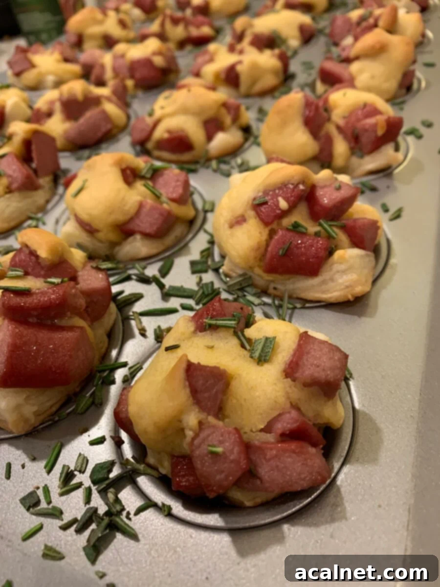 Golden brown corn dog nuggets baked in a mini muffin pan