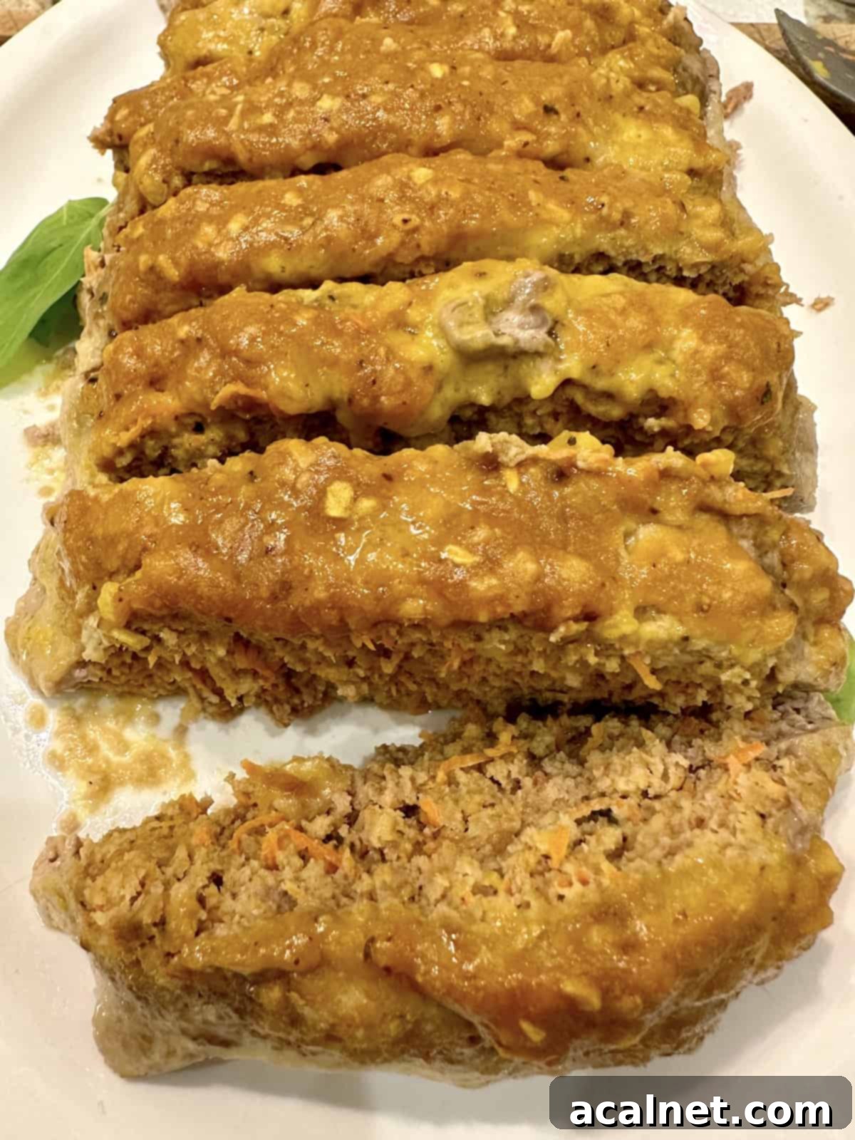 Meatloaf Beyond Ketchup 2 Sliced no-ketchup meatloaf on a platter, showcasing its juicy texture and golden glaze.