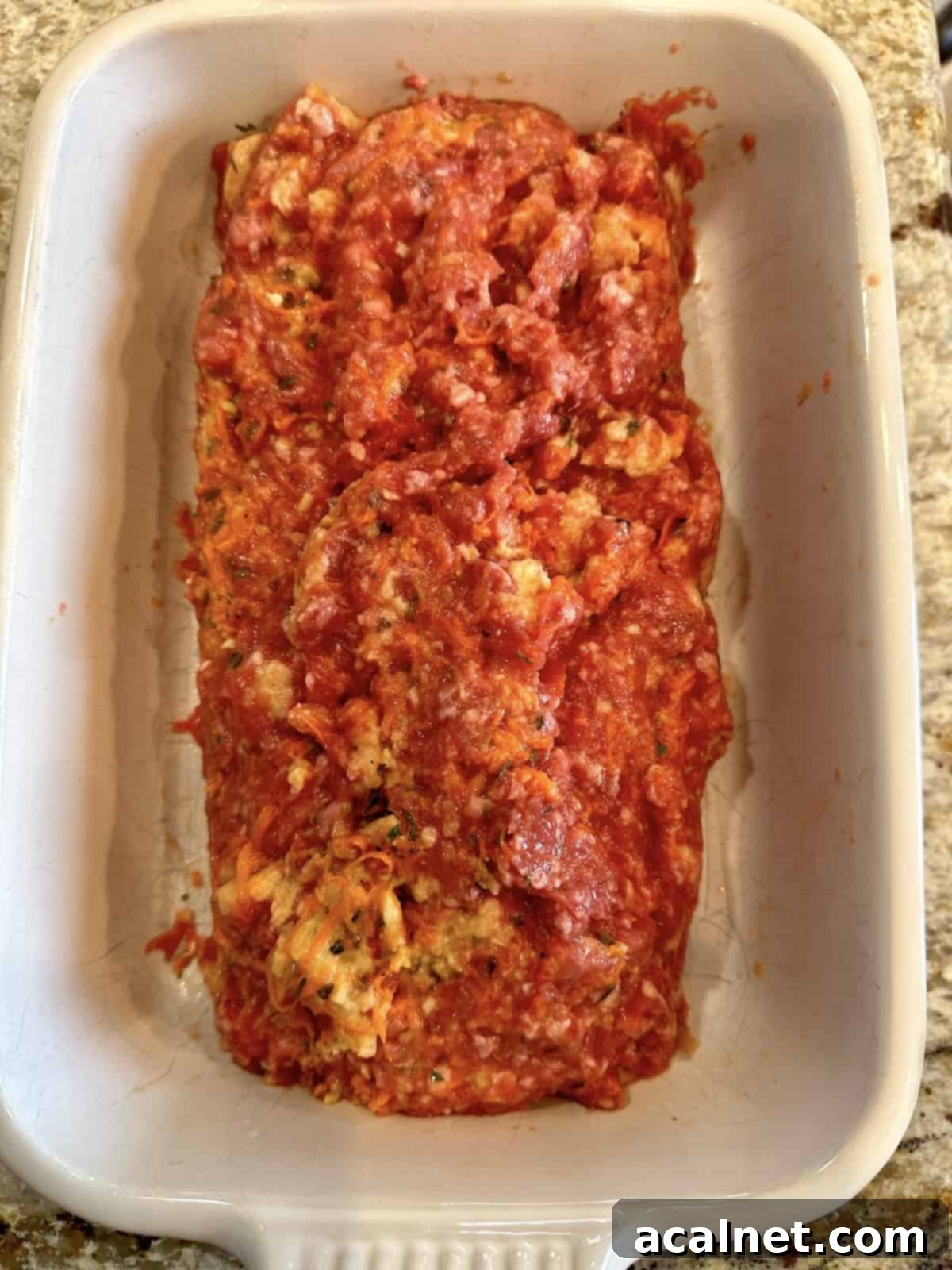 Meatloaf Beyond Ketchup 4 Unbaked no-ketchup meatloaf shaped in a ceramic baking dish, ready for the oven.