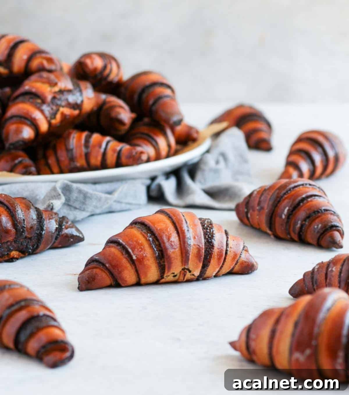 Chocolate pastries on a grey surface.