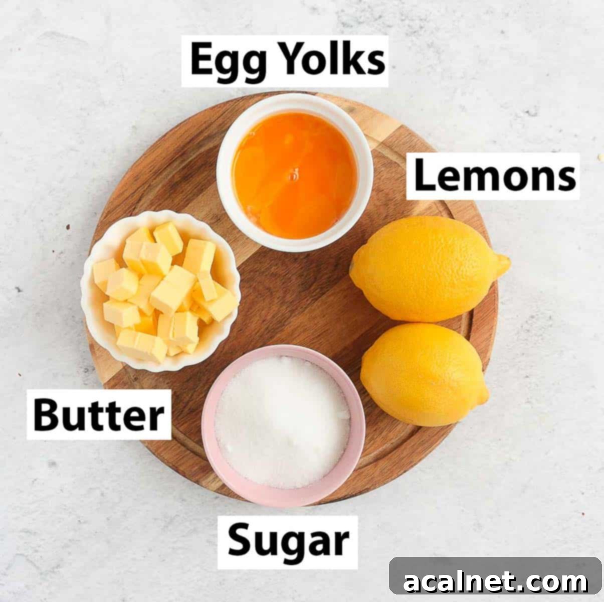 Zesty Lemon Delight 3 A beautifully arranged spread of lemon curd ingredients: fresh lemons, butter, sugar, and egg yolks on a rustic wooden board.