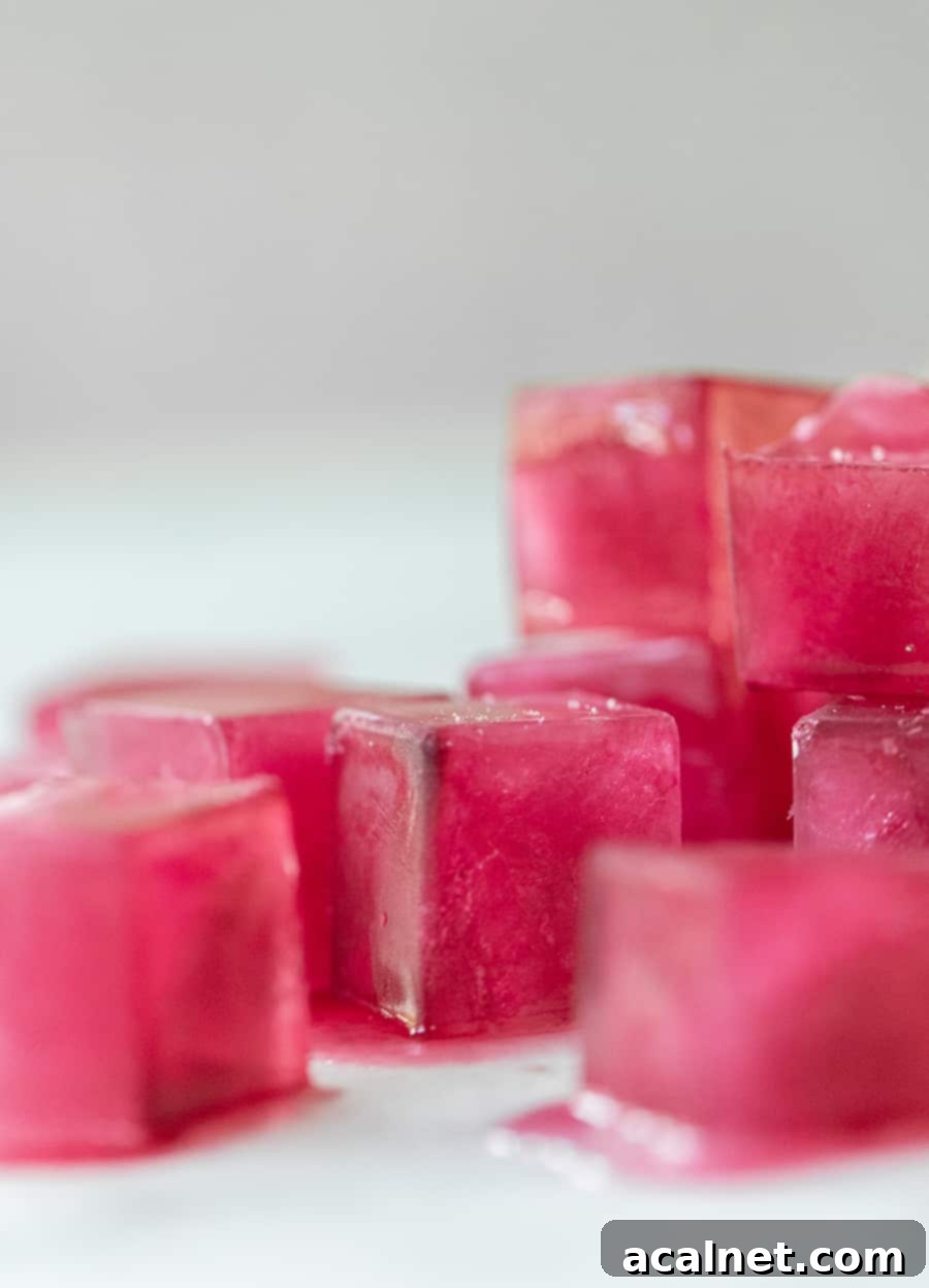 Beautiful natural pink ice cubes in a glass with a drink.