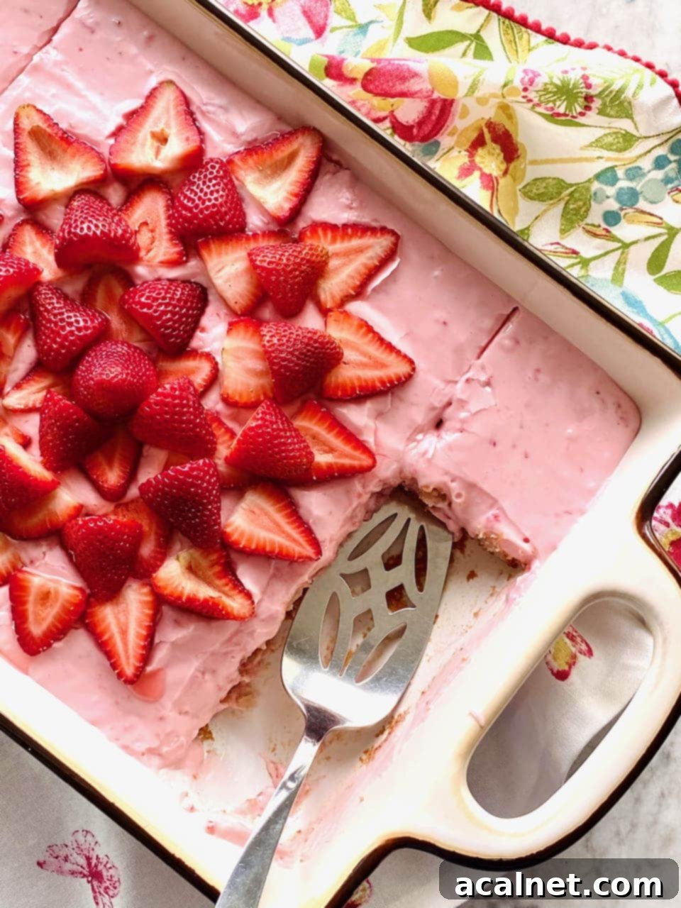 A slice of elegant vintage strawberry cake with white frosting and fresh strawberries.