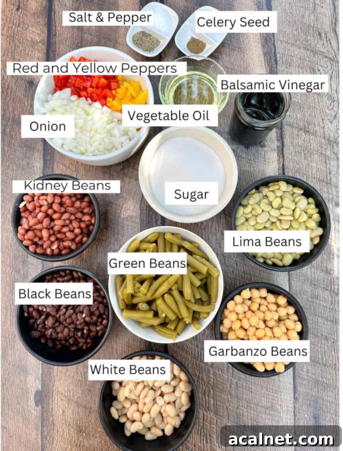 Cold Green Bean Salad ingredients arranged in individual bowls on a table with labels on each ingredient.