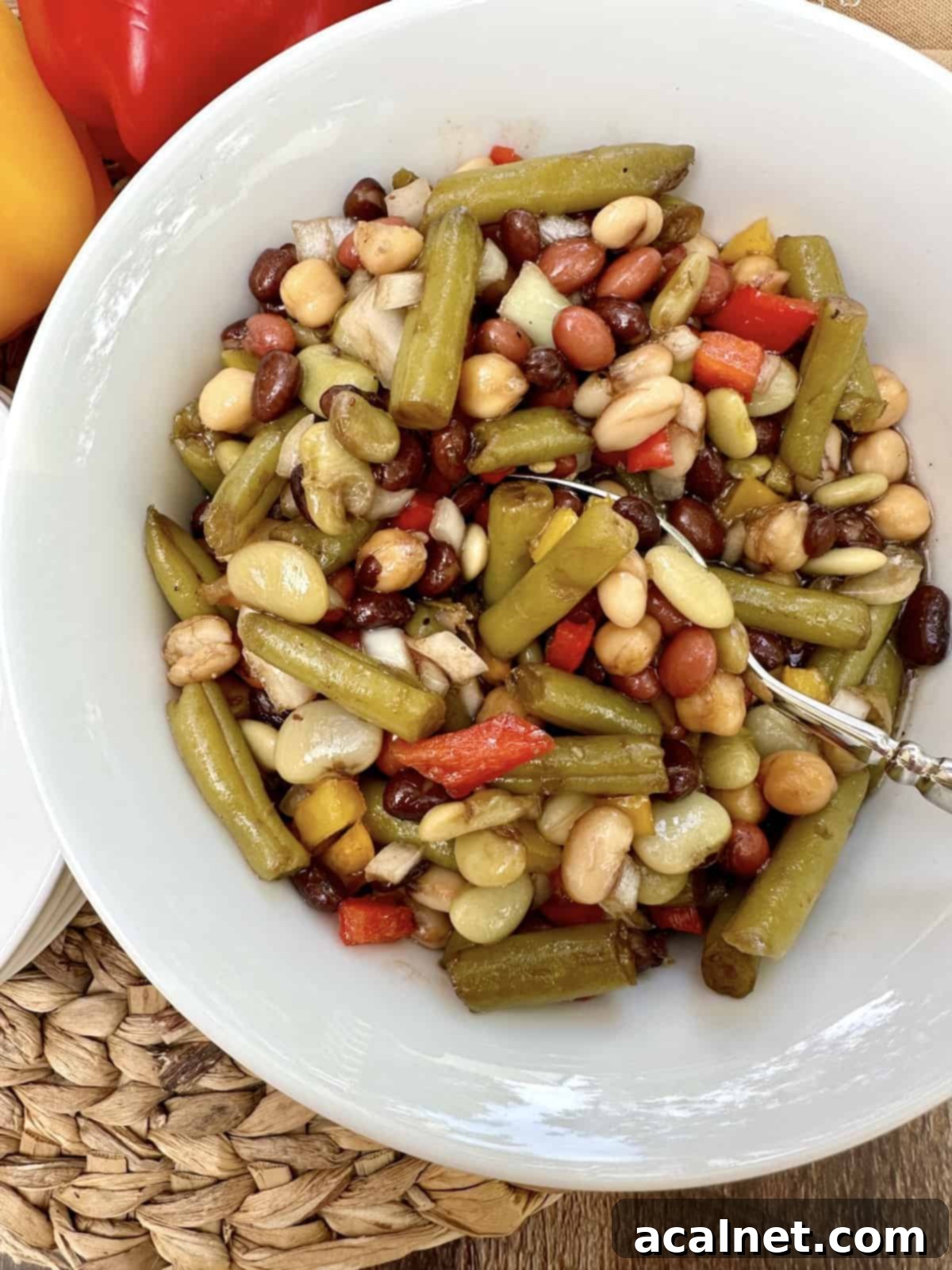 A spoon dishing up serving of bean salad.