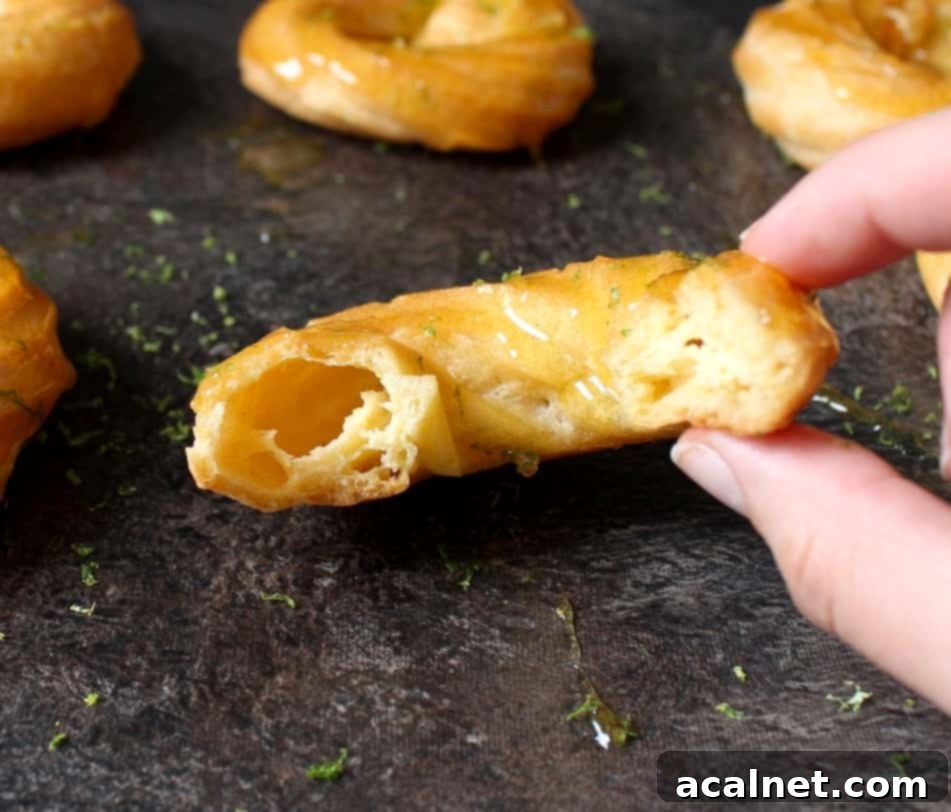 Honey Lemon Glazed French Crullers 5 A crumb shot of a French Cruller Donut cut in half, revealing its incredibly light, airy, and hollow interior texture.
