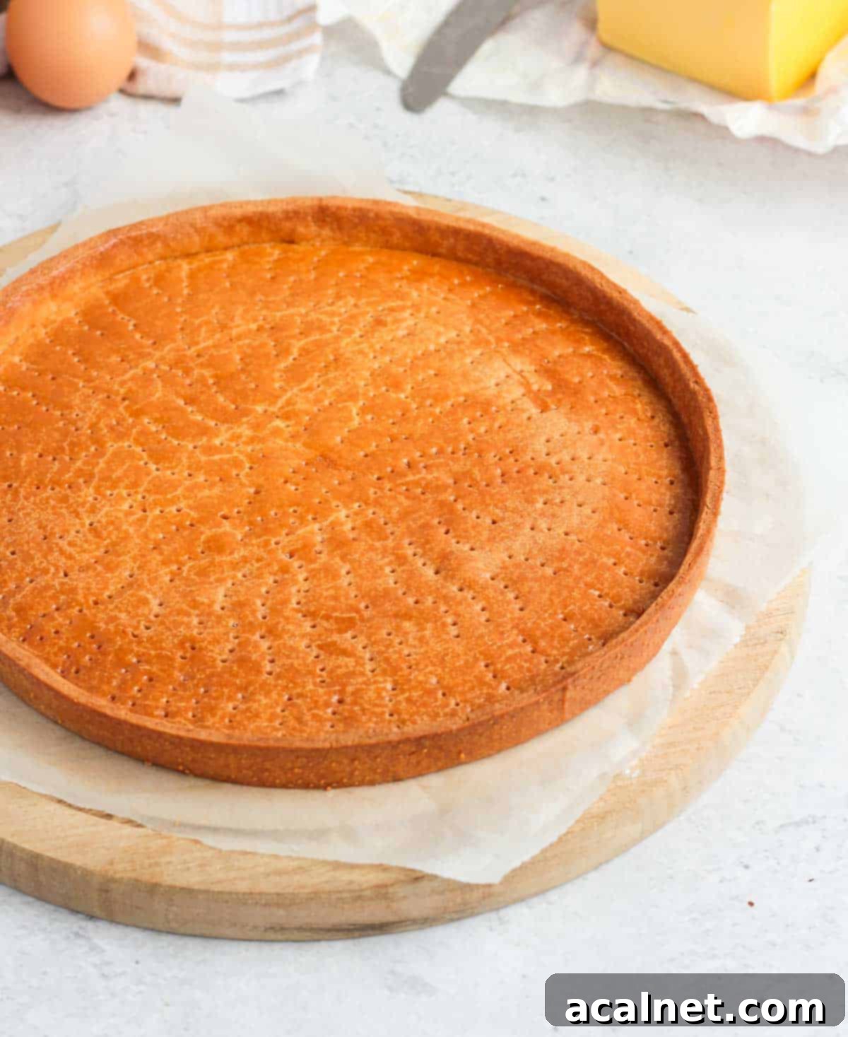 Baked Pastry Crust on a round wooden board.