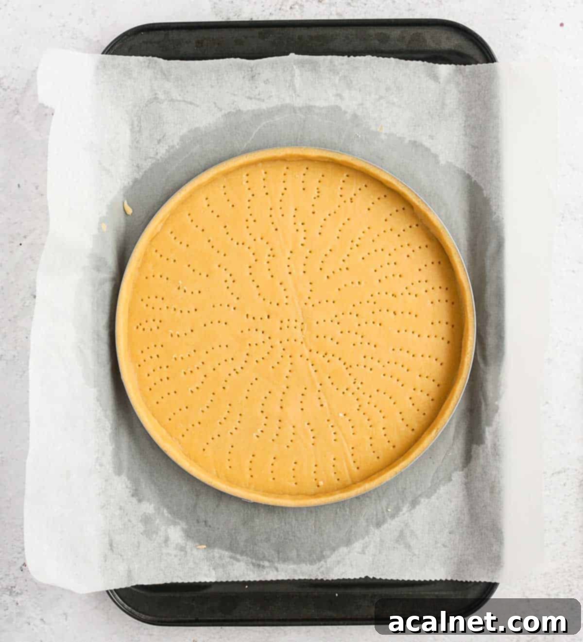 Unbaked Pate Sablee lined into a tart ring.