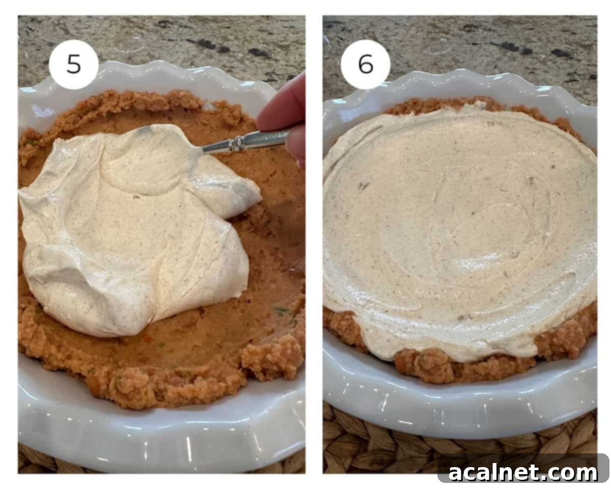 Layered taco dip with the sour cream layer carefully spread on top of the bean layer.