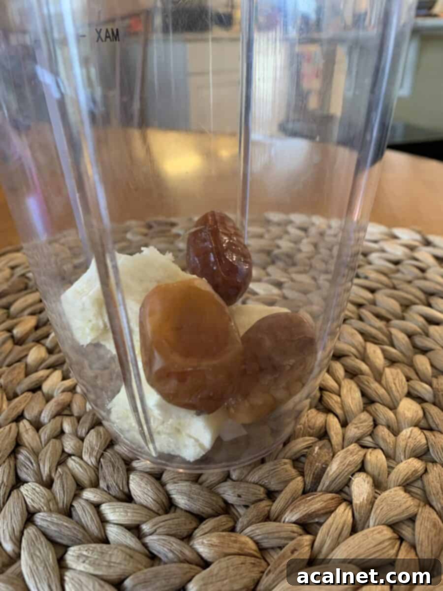 Banana and pitted dates in a blender cup.