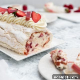 A stunning Strawberry Rhubarb Meringue Roulade, showcasing its swirled layers and fresh fruit.