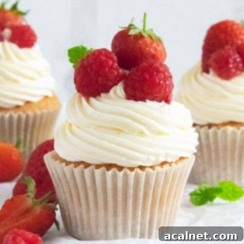Delicious Strawberries and Cream Cupcakes, topped with clotted cream buttercream and fresh fruit.