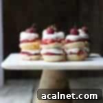 Adorable Mini Strawberry Shortcake Stacks, layered with biscuits, strawberries, and whipped cream.