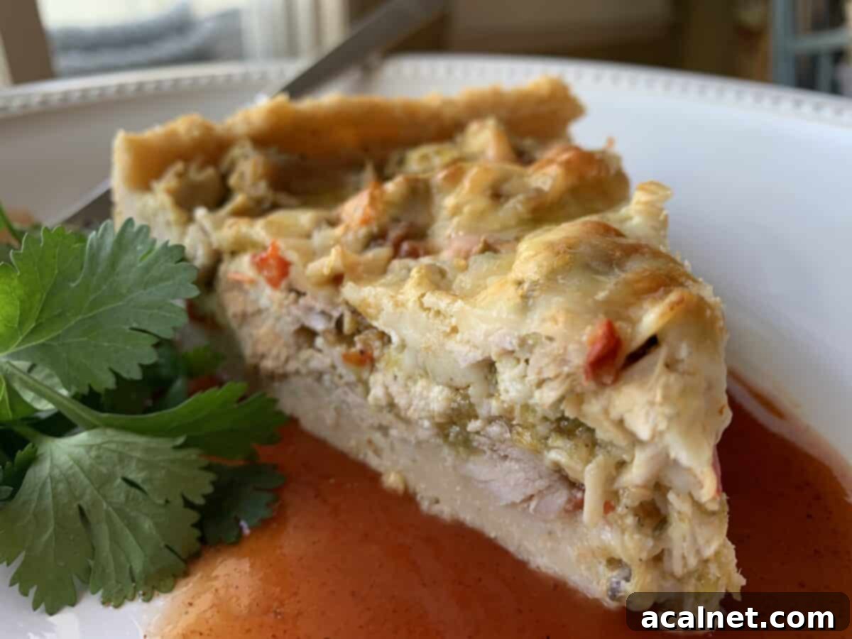 A beautifully presented wedge of tamale casserole on a white plate, garnished with fresh cilantro, ready to be enjoyed as a hearty meal.