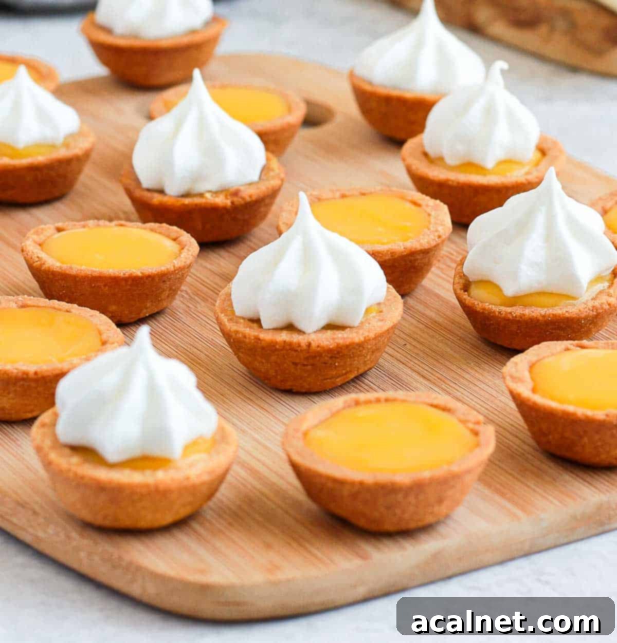 Piping the meringue over the lemon curd filling.