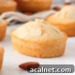 Close up on one almond cake over a white surface.