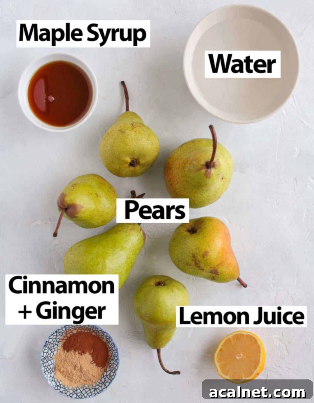 A selection of fresh pears, golden maple syrup, a vibrant lemon, ground cinnamon, and ground ginger laid out on a clean white surface, showcasing the simple ingredients for pear compote.