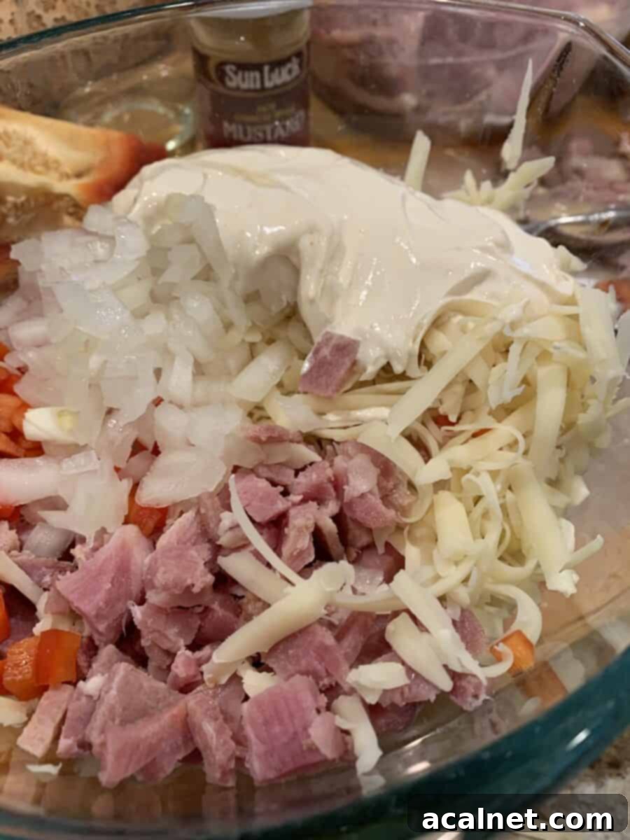 A colorful mixture of diced ham, red pepper, and green onions, ready for the wonton filling.