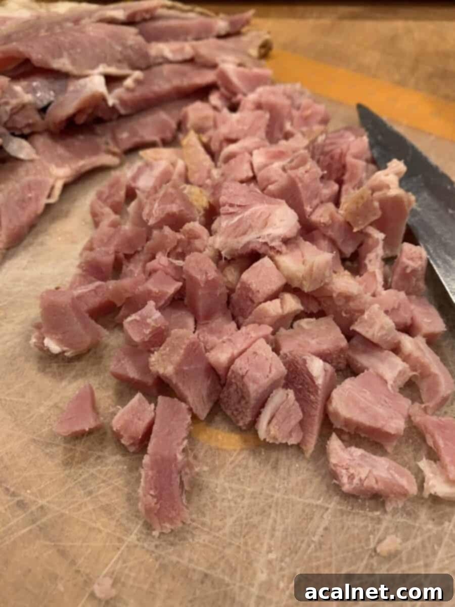 Small, uniformly diced pieces of cooked ham, ready for the wonton filling mixture.