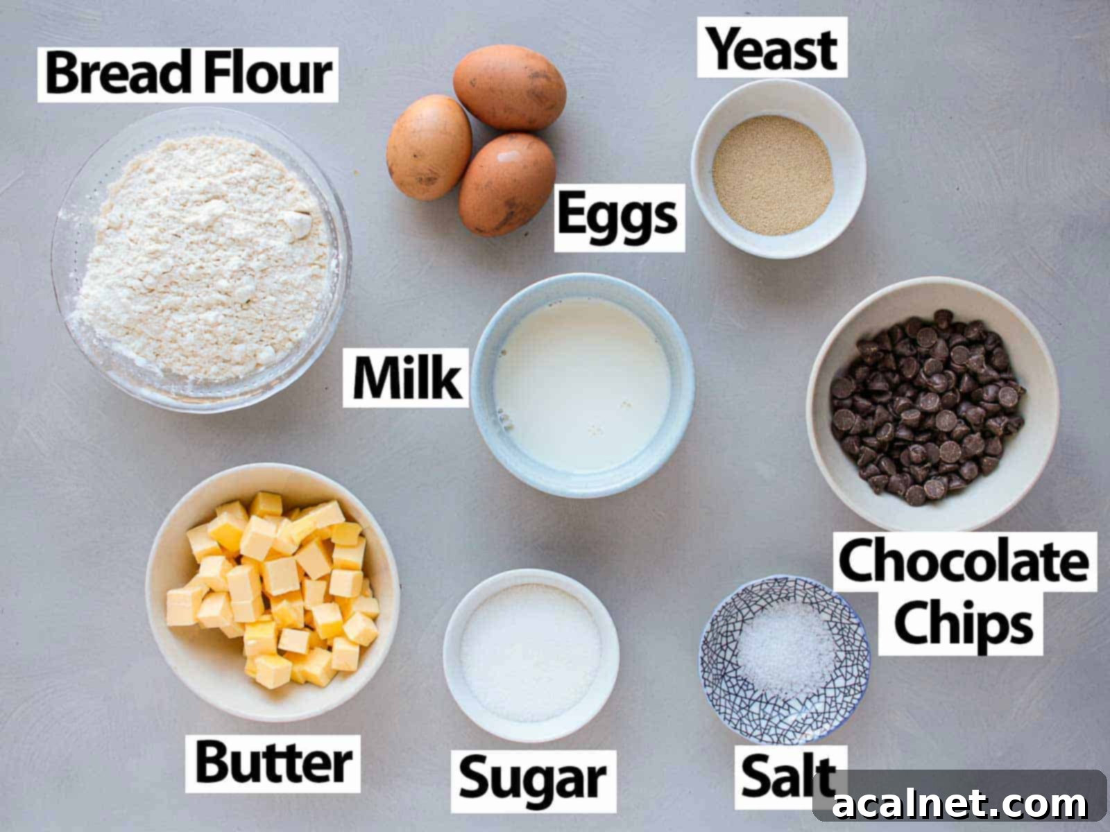 A selection of high-quality ingredients laid out on a grey surface, ready for baking.