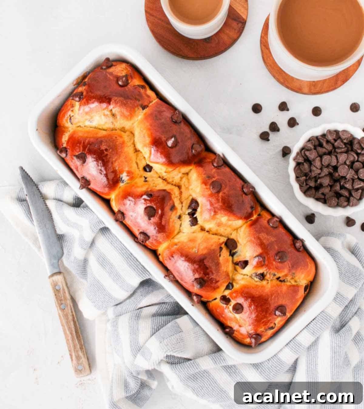 Freshly baked chocolate chip brioche loaf in the pan, seen from above.