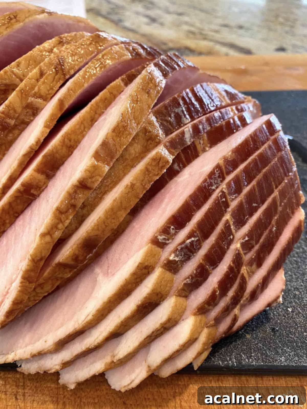 A pre-sliced ham on a cutting board, showing the convenience of not needing to score.