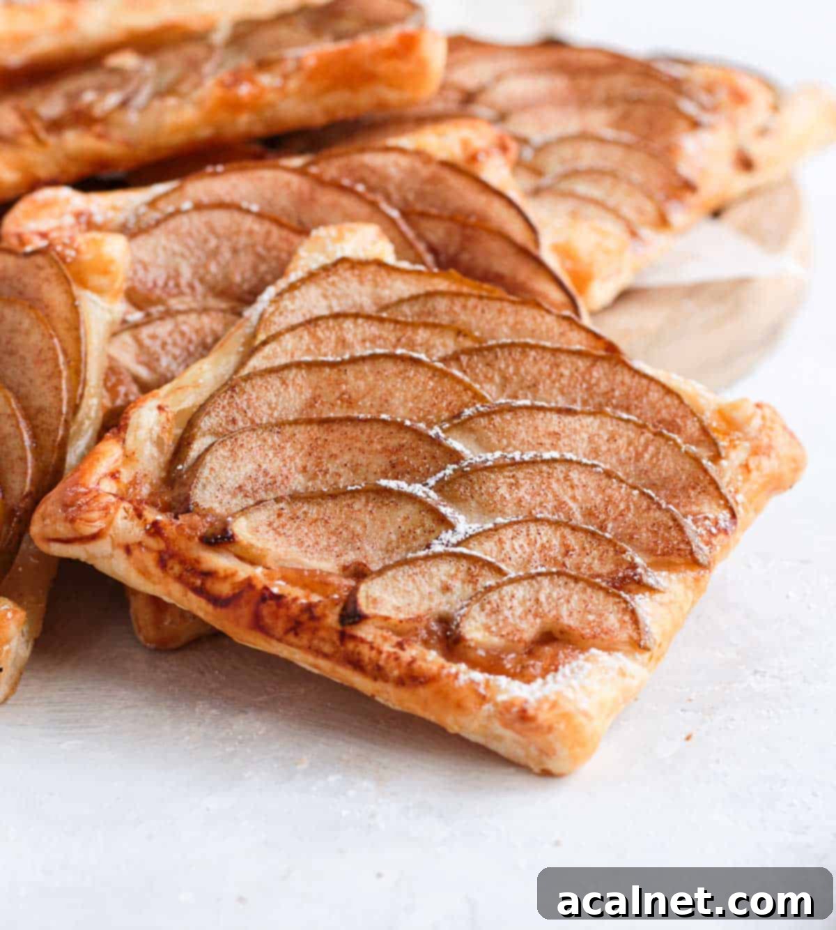 Close up on one tartlet next to a stack of pastries.