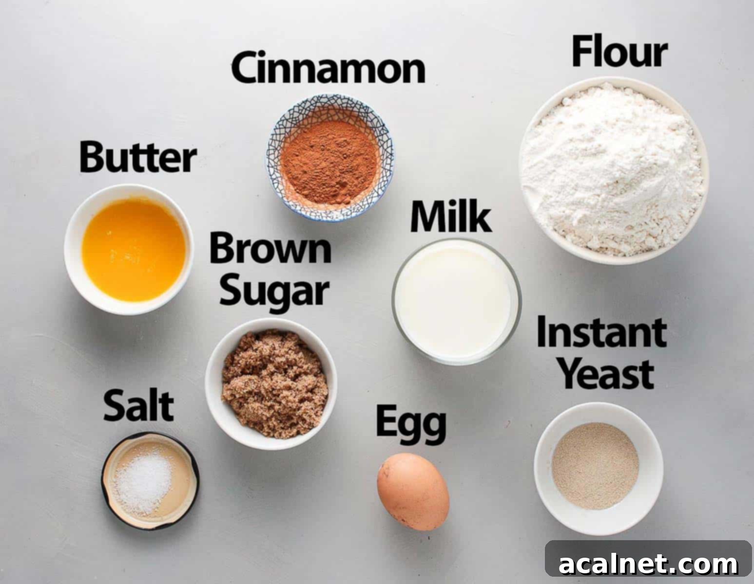 Ingredients for cinnamon rolls on a grey surface.