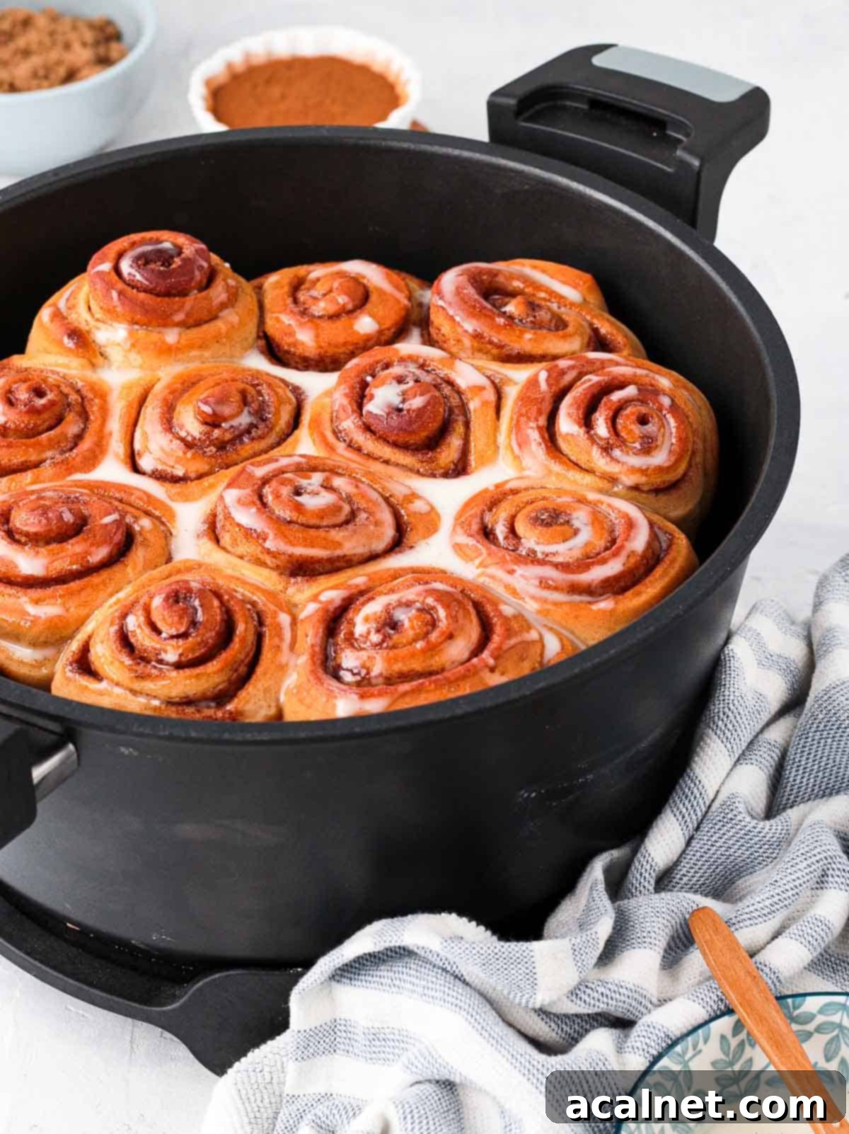 Cinnamon Rolls glazed with icing inside the remoska pot.