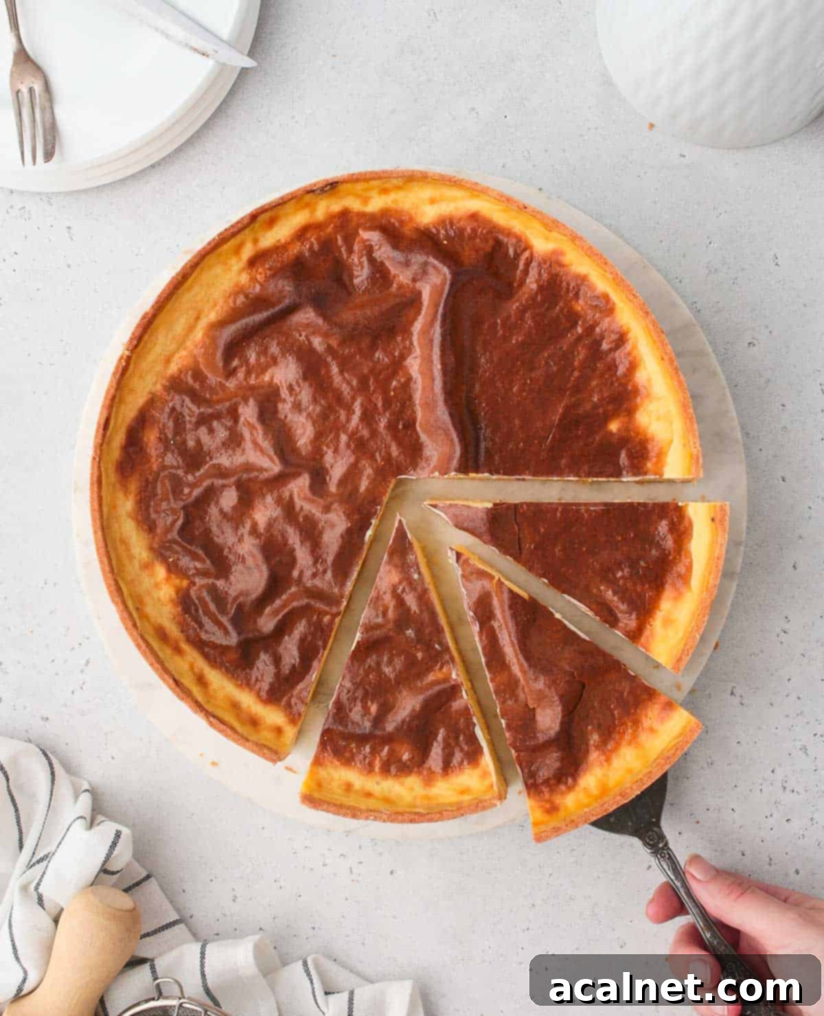 A close-up overhead shot of a baked Parisian Flan with three slices already removed, showing the golden-brown top and pale, creamy custard beneath.
