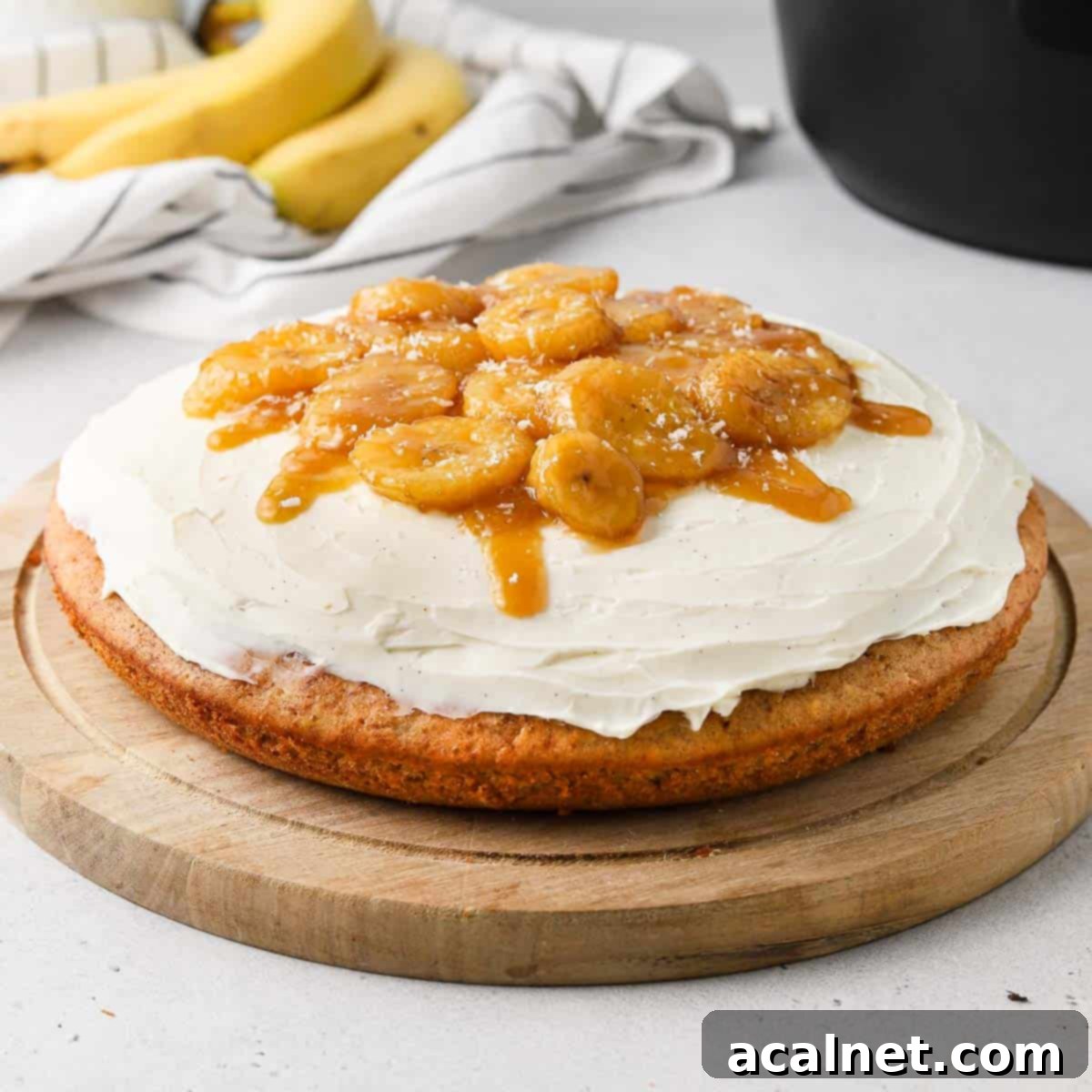Delicious Banana Bread Cake with Cream Cheese Frosting and Caramelized Bananas, ready to be served, baked in a Remoska Tria.