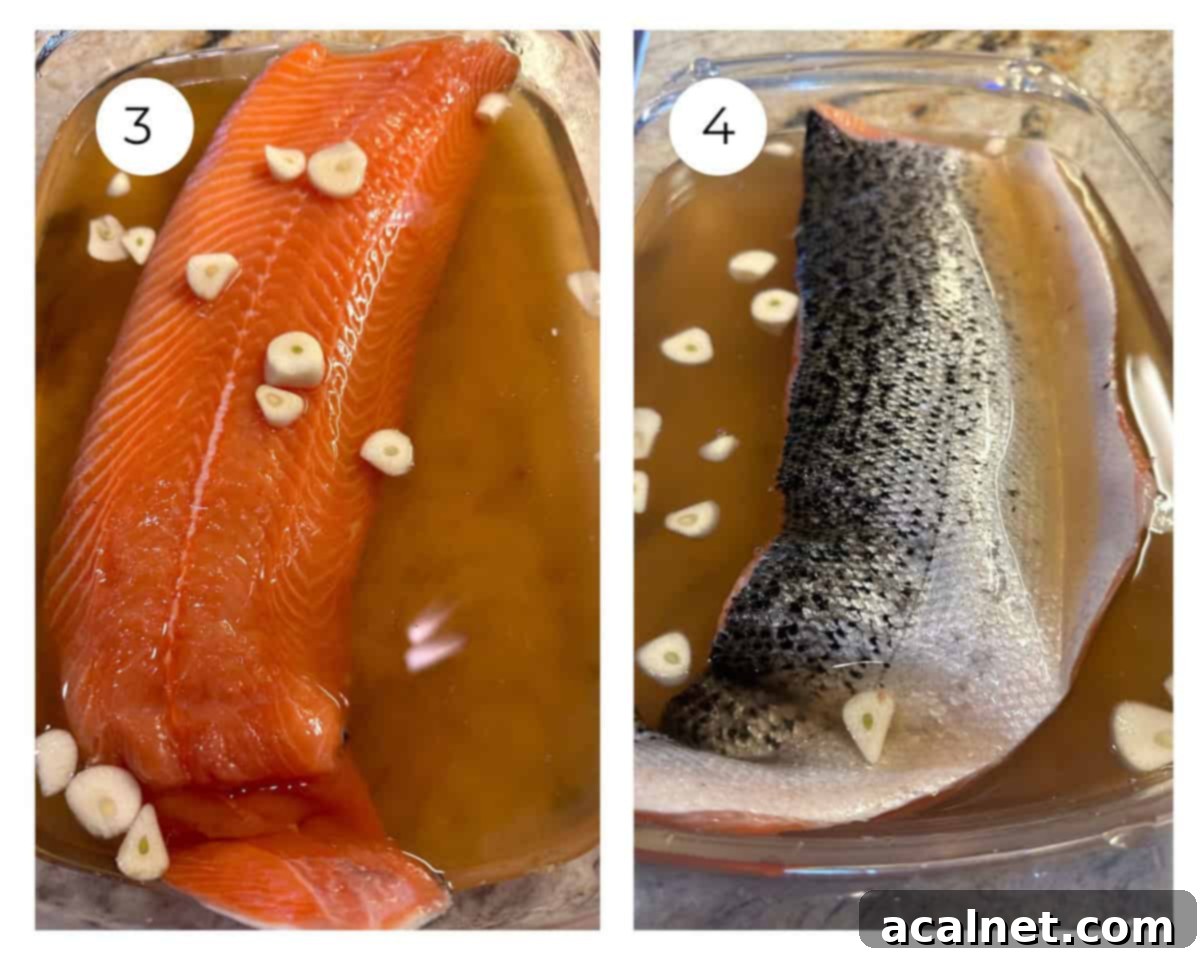 A salmon fillet submerged in the brine solution within a glass dish, ready for chilling.