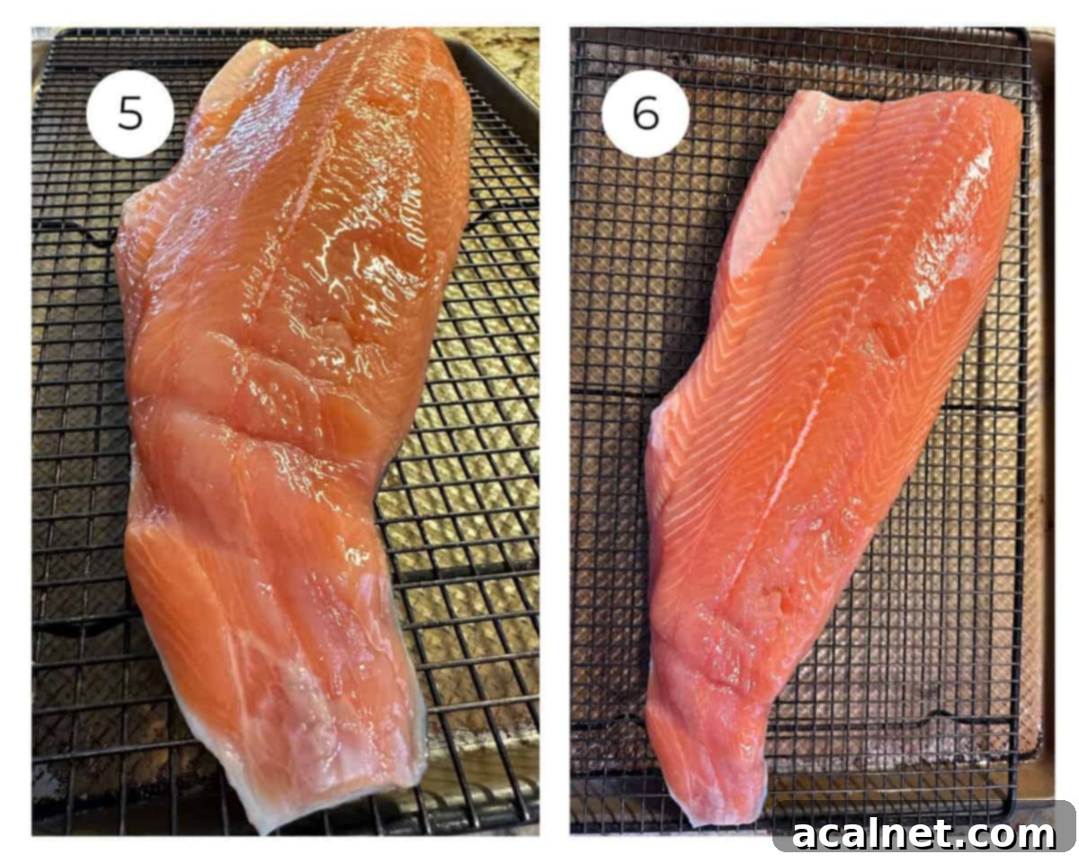A brined salmon fillet placed on a wire rack over a baking sheet, drying at room temperature to form a pellicle.