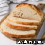 No Knead Bread in the Remoska 10 3 slices of bread cut off, revealing a soft, airy crumb.