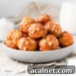 Chouquettes stacked in a grey bowl.
