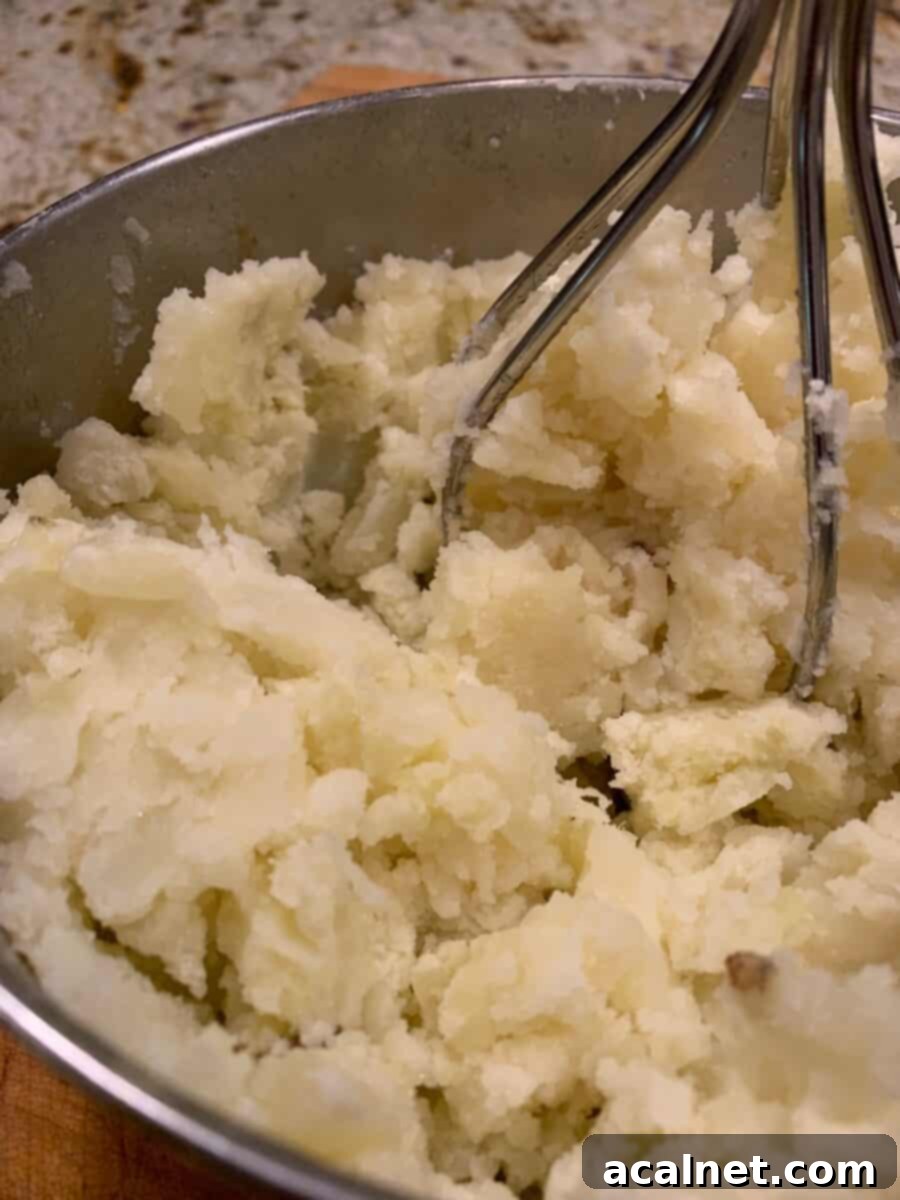Freshly made mashed potatoes in a metal bowl, ready for the roll dough