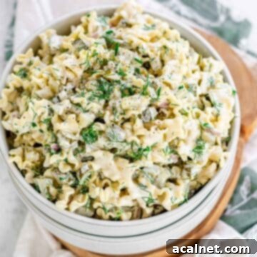 A bowl of creamy Dill Pickle Pasta Salad, garnished with fresh dill, showcasing its unique tangy flavor.