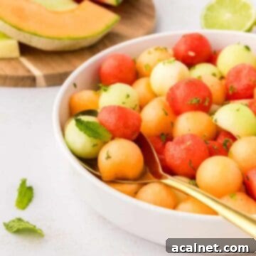 A colorful and refreshing Melon Salad featuring cubes of watermelon, cantaloupe, and honeydew in a bowl.