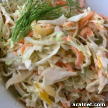 A delightful serving of Crunchy Cole Slaw in a bowl, highlighting its crisp texture and fresh ingredients.