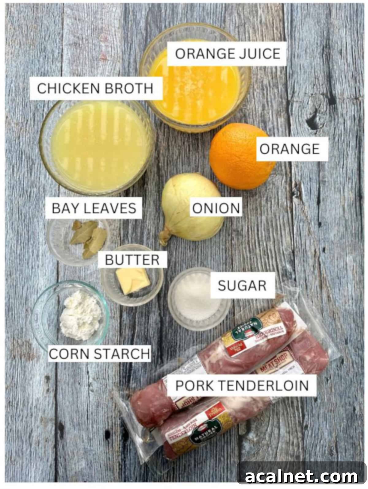 Orange pork tenderloin ingredients on a wooden table with labels.