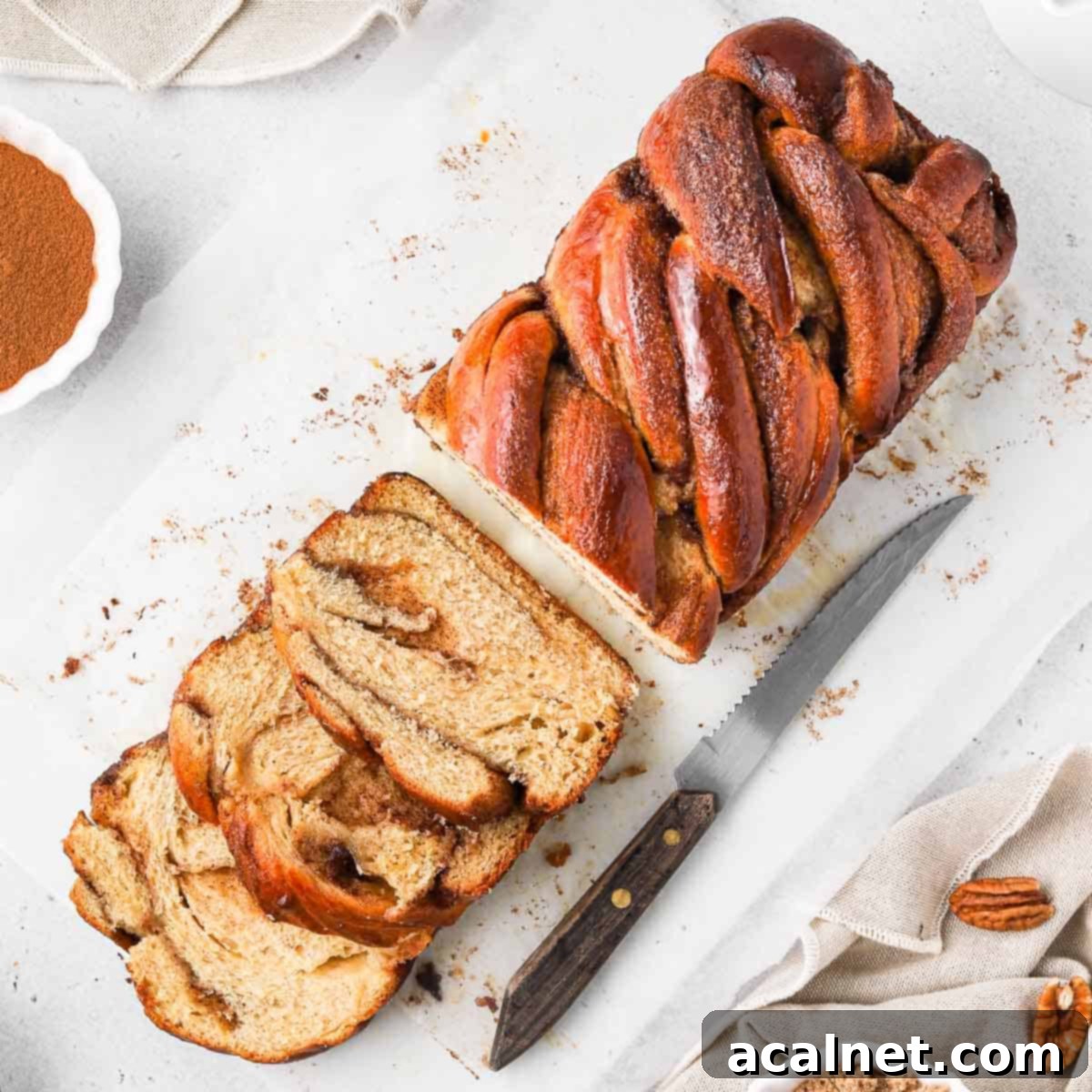 Cinnamon Babka seen from above with 3 slices cut off, showcasing its beautiful swirls and golden crust.