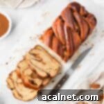 Cinnamon Babka seen from above with 3 slices cut off, showing the golden crust and internal swirls.